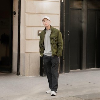 Olive Bomber Jacket Outfits For Men: Go for an olive bomber jacket and black chinos for comfort dressing with a modern twist. White athletic shoes are the most effective way to inject a touch of stylish nonchalance into this outfit.