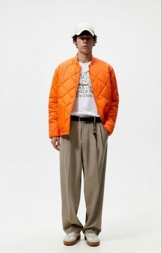 Orange Quilted Bomber Jacket Outfits For Men: An orange quilted bomber jacket and brown chinos are great menswear essentials that will integrate really well within your current lineup. White leather low top sneakers are a stylish accompaniment to this look.