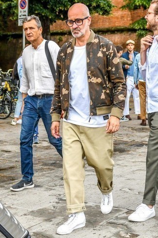 Brown Camouflage Bomber Jacket Outfits For Men: A brown camouflage bomber jacket and khaki chinos are among the key pieces in any modern gentleman's functional off-duty collection. When this outfit looks too polished, play it down by sporting a pair of white canvas high top sneakers.