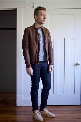 Dark Brown Leather Bomber Jacket Outfits For Men: If it's ease and practicality that you appreciate in menswear, marry a dark brown leather bomber jacket with navy chinos. If you wish to easily dial down your look with one item, why not complete this ensemble with a pair of beige canvas low top sneakers?