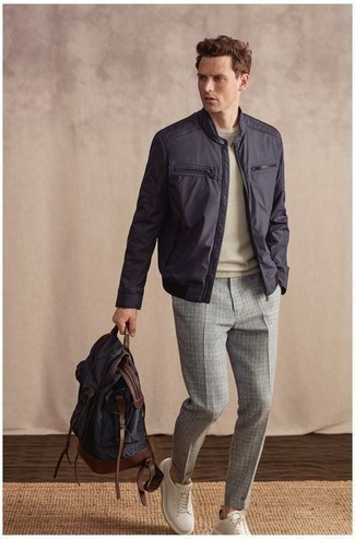 Navy Backpack Outfits For Men: This off-duty combination of a navy bomber jacket and a navy backpack couldn't possibly come across as anything other than outrageously stylish. Punch up your look with a pair of white leather low top sneakers.