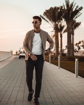 Tan Bomber Jacket Outfits For Men: Consider teaming a tan bomber jacket with black vertical striped chinos if you seek to look laid-back and cool without much effort. Complete this look with a pair of black suede low top sneakers and you're all set looking awesome.