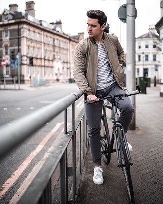Tan Bomber Jacket Outfits For Men: This laid-back combo of a tan bomber jacket and charcoal chinos is extremely easy to put together in no time flat, helping you look amazing and prepared for anything without spending a ton of time going through your wardrobe. Give a carefree feel to this look with white canvas low top sneakers.