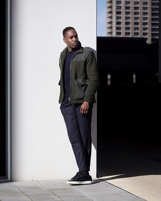 Olive Bomber Jacket Outfits For Men: Dapper yet comfortable, this look is comprised of an olive bomber jacket and navy vertical striped chinos. If you're clueless about how to round off, a pair of black suede low top sneakers is a fail-safe option.