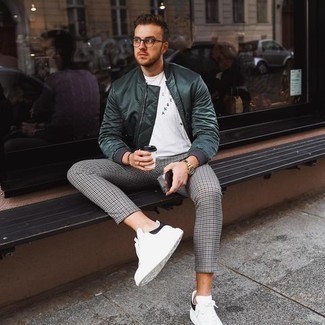 Olive Bomber Jacket Outfits For Men: Fashionable and practical, this casual combination of an olive bomber jacket and grey houndstooth chinos provides amazing styling possibilities. Complete your ensemble with white and black leather low top sneakers and the whole look will come together.