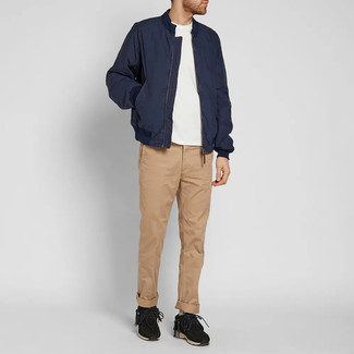 Navy Bomber Jacket Outfits For Men: If you're after a casual yet seriously stylish outfit, wear a navy bomber jacket with khaki chinos. For something more on the casual and cool side to finish your outfit, introduce a pair of black athletic shoes to the equation.