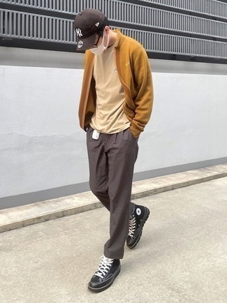 Black Canvas High Top Sneakers Outfits For Men: A tobacco bomber jacket and dark brown chinos are the kind of a fail-safe off-duty combo that you so awfully need when you have no extra time to spare. Loosen things up and complete this look with a pair of black canvas high top sneakers.