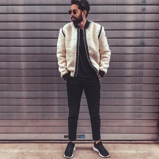 Beige Fleece Bomber Jacket Outfits For Men: Combining a beige fleece bomber jacket with black chinos is an amazing option for a casual and cool outfit. Black and white athletic shoes are a surefire way to add a dose of stylish casualness to this ensemble.