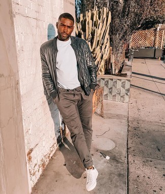 Charcoal Bomber Jacket Outfits For Men: You'll be amazed at how easy it is for any gentleman to pull together this laid-back outfit. Just a charcoal bomber jacket and brown chinos. Feeling transgressive? Jazz up this look by sporting a pair of white canvas low top sneakers.