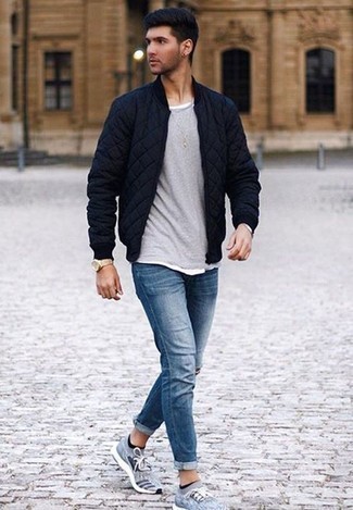 Navy Ripped Jeans Outfits For Men: This casual pairing of a navy quilted bomber jacket and navy ripped jeans is very versatile and really up for whatever the day throws at you. Add a laid-back vibe to by wearing light blue athletic shoes.