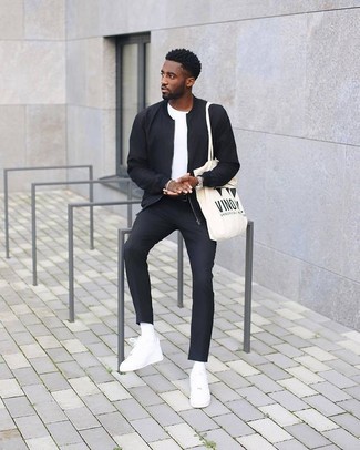 White Print Canvas Tote Bag Outfits For Men: Exhibit your skills in men's fashion by pairing a black bomber jacket and a white print canvas tote bag for an urban combination. Take this look in a more elegant direction by slipping into a pair of white leather low top sneakers.
