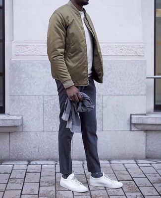 Blue Scarf Outfits For Men: If you’re a jeans-and-a-tee kind of dresser, you'll like this low-key yet neat and relaxed combo of an olive bomber jacket and a blue scarf. Go ahead and add a pair of white canvas low top sneakers to the equation for an added dose of sophistication.