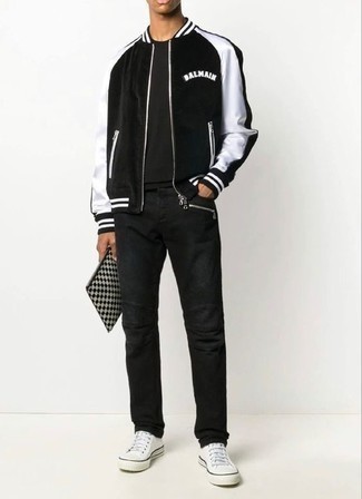 Zip Pouch Outfits For Men: If you're in search of an off-duty yet stylish look, consider pairing a black and white bomber jacket with a zip pouch. Complement this getup with white canvas low top sneakers for an air of class.