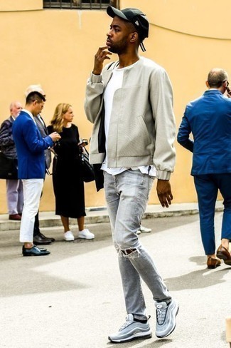 Grey Bomber Jacket Outfits For Men: For an outfit that's pared-down but can be worn in a great deal of different ways, pair a grey bomber jacket with light blue ripped jeans. Infuse a mellow vibe into your getup with a pair of light blue athletic shoes.