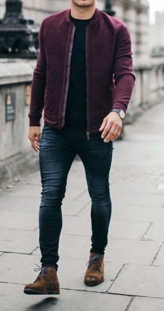 A burgundy bomber jacket and navy jeans are a favorite combo for many fashion-forward gents. The whole outfit comes together if you introduce a pair of brown suede desert boots to this outfit.