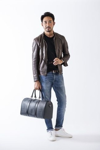 Brown Leather Bomber Jacket Outfits For Men: Wear a brown leather bomber jacket with blue jeans to don a casually cool ensemble. White canvas low top sneakers finish this outfit quite nicely.