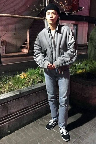 Grey Bomber Jacket Outfits For Men: A grey bomber jacket and light blue jeans are a combination that every sharp guy should have in his casual rotation. Black and white canvas low top sneakers are a welcome companion to your ensemble.