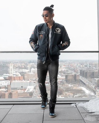 Black Canvas High Top Sneakers Outfits For Men: Make a black print bomber jacket and charcoal ripped jeans your outfit choice for relaxed dressing with an edgy twist. The whole outfit comes together when you add a pair of black canvas high top sneakers to this ensemble.