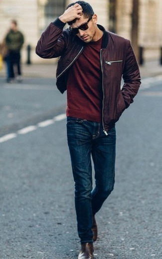Burgundy Bomber Jacket Outfits For Men: If you're on the hunt for an off-duty and at the same time sharp outfit, consider pairing a burgundy bomber jacket with navy jeans. Up your ensemble by finishing off with dark brown leather chelsea boots.