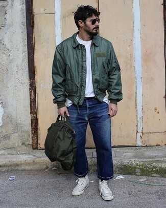 Olive Bomber Jacket Outfits For Men: The combo of an olive bomber jacket and navy jeans makes for a killer casual look. Complement your outfit with white canvas high top sneakers to make a standard look feel suddenly fun and fresh.