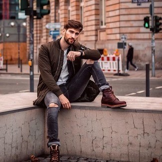 Dark Brown Bomber Jacket Outfits For Men: A dark brown bomber jacket and charcoal ripped jeans teamed together are a match made in heaven for those who prefer casual and cool styles. Rounding off with burgundy leather work boots is the most effective way to add a laid-back vibe to this ensemble.