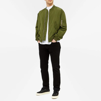 Olive Bomber Jacket Outfits For Men: This laid-back combo of an olive bomber jacket and black jeans is super easy to throw together without a second thought, helping you look amazing and prepared for anything without spending a ton of time searching through your wardrobe. A great pair of black canvas low top sneakers ties this getup together.