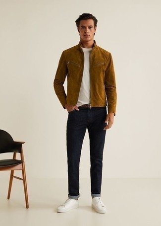 Tobacco Bomber Jacket Outfits For Men: You'll be surprised at how super easy it is for any man to get dressed this way. Just a tobacco bomber jacket and navy jeans. Let your sartorial skills truly shine by complementing your look with white canvas low top sneakers.