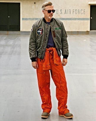 Olive Canvas Work Boots Outfits For Men: If you enjoy a more casual approach to styling, why not team an olive embroidered bomber jacket with orange overalls? Hesitant about how to finish off? Add olive canvas work boots to the mix to change things up a bit.