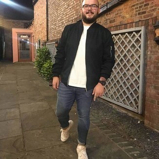 Beige Athletic Shoes Outfits For Men: This laid-back combo of a black bomber jacket and navy skinny jeans is a winning option when you need to look casually dapper in a flash. Beige athletic shoes will instantly play down a smart outfit.