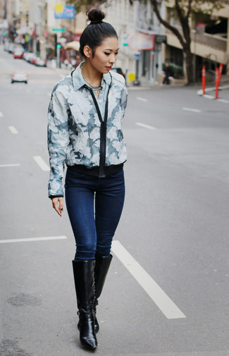 Black Leather Knee High Boots Outfits: Go for a navy and white floral bomber jacket and navy skinny jeans for relaxed dressing with a twist. For a smarter vibe, complete your outfit with a pair of black leather knee high boots.