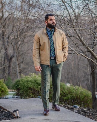 Tan Bomber Jacket Outfits For Men: This classy combination of a tan bomber jacket and dark green dress pants is a favored choice among the fashion-forward guys. Let your styling savvy truly shine by finishing your ensemble with burgundy leather loafers.
