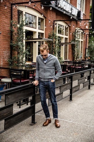 Grey Bomber Jacket Outfits For Men: Such pieces as a grey bomber jacket and navy jeans are the perfect way to inject muted dapperness into your day-to-day outfit choices. Rev up the dressiness of this getup a bit by finishing with brown leather oxford shoes.