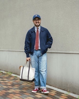 Navy Baseball Cap Outfits For Men: A navy bomber jacket and a navy baseball cap are essential in any modern man's versatile off-duty sartorial collection. Complete this ensemble with a pair of red canvas low top sneakers for an extra dose of style.