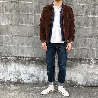 Dark Brown Bomber Jacket Outfits For Men: If you enjoy the comfort look, consider pairing a dark brown bomber jacket with navy jeans. Add a pair of white canvas low top sneakers to the equation and ta-da: your outfit is complete.