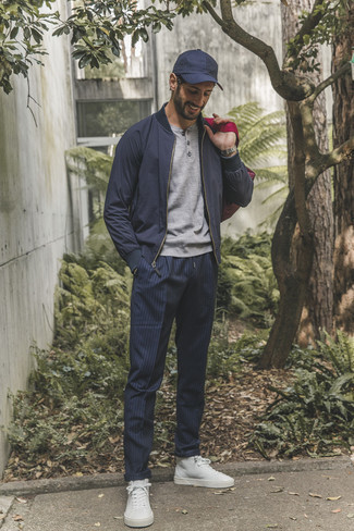 Blue Vertical Striped Chinos Outfits: The versatility of a navy bomber jacket and blue vertical striped chinos means you'll always have them on high rotation in your menswear collection. Up this whole ensemble by sporting white canvas high top sneakers.