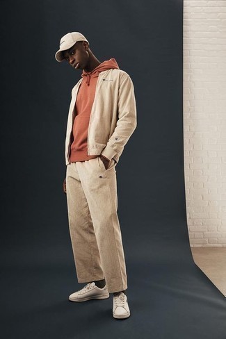 Beige Bomber Jacket Outfits For Men: Perfect the cool and casual look by wearing a beige bomber jacket and beige chinos. White leather low top sneakers are a fail-safe way to give an air of stylish effortlessness to this look.