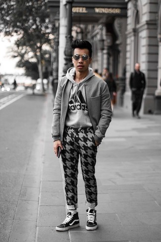 Grey Print Hoodie Outfits For Men: This street style combination of a grey print hoodie and grey houndstooth chinos is very easy to throw together in no time, helping you look on-trend and ready for anything without spending too much time combing through your wardrobe. Complete this ensemble with black and white canvas high top sneakers and the whole look will come together.