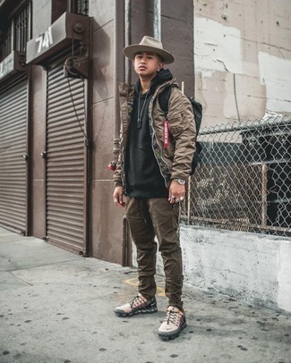 Brown Bomber Jacket Outfits For Men: This laid-back pairing of a brown bomber jacket and brown chinos is a tested option when you need to look stylish in a flash. Complete your look with beige athletic shoes to keep the ensemble fresh.