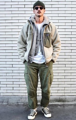 Olive Canvas Belt Chill Weather Outfits For Men: A beige fleece bomber jacket and an olive canvas belt are true staples if you're putting together an off-duty wardrobe that matches up to the highest sartorial standards. Add black and white canvas low top sneakers to the equation to immediately amp up the fashion factor of any look.