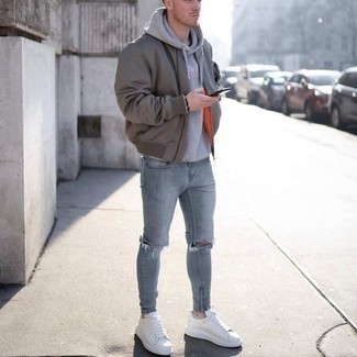 Light Blue Ripped Skinny Jeans Outfits For Men: If the setting allows a casual outfit, you can easily rock a grey bomber jacket and light blue ripped skinny jeans. To add some extra depth to your outfit, add a pair of white leather low top sneakers.