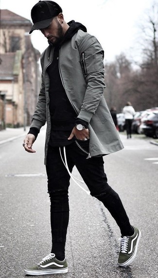 Dark Green Canvas Low Top Sneakers Outfits For Men: Flaunt your credentials in men's fashion by wearing this bold casual combination of a grey bomber jacket and black ripped skinny jeans. And if you want to easily smarten up this ensemble with one piece, complement your ensemble with a pair of dark green canvas low top sneakers.