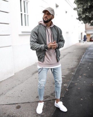Beige Print Hoodie Outfits For Men: Choose a beige print hoodie and light blue ripped skinny jeans to achieve an extra dapper and contemporary ensemble. A pair of white canvas low top sneakers will bring a different twist to an otherwise straightforward ensemble.