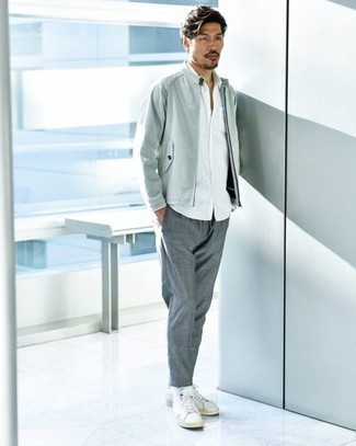 Men's Outfits 2022: If you feel more confident wearing something comfortable, you'll like this sharp combination of a grey bomber jacket and grey chinos. Get a bit experimental on the shoe front and grab a pair of white leather high top sneakers.