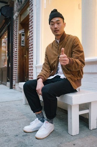 Beige Bomber Jacket Outfits For Men: This casual combo of a beige bomber jacket and black chinos will catch attention for all the right reasons. Give a more casual twist to your look by rocking white leather low top sneakers.
