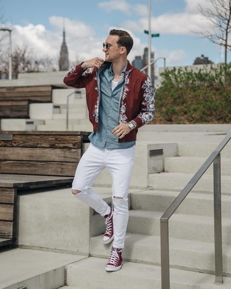 Red High Top Sneakers Outfits For Men: This street style combination of a burgundy floral bomber jacket and white ripped skinny jeans is very easy to throw together without a second thought, helping you look sharp and prepared for anything without spending a ton of time going through your wardrobe. When it comes to footwear, opt for red high top sneakers.