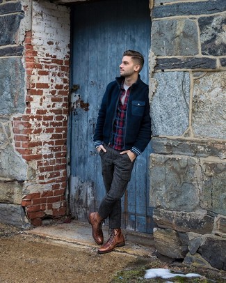 Navy Bomber Jacket Outfits For Men: Such pieces as a navy bomber jacket and charcoal wool cargo pants are an easy way to introduce extra cool into your day-to-day off-duty routine. Rev up the classiness of this look a bit by rounding off with a pair of brown leather casual boots.
