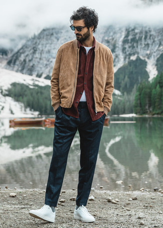Tan Suede Bomber Jacket Outfits For Men: Consider teaming a tan suede bomber jacket with navy chinos to show you've got serious styling prowess. Why not take a more relaxed approach with shoes and complete your outfit with white canvas low top sneakers?