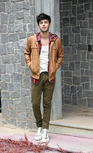 Tan Bomber Jacket Outfits For Men In Their Teens: A tan bomber jacket and olive chinos married together are a perfect match. A pair of white leather high top sneakers immediately ramps up the street cred of this ensemble. This pairing demonstrates that a teenage boy's sartorial options are looking great.