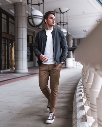 Grey Vertical Striped Bomber Jacket Outfits For Men: Consider teaming a grey vertical striped bomber jacket with brown chinos to assemble a neat and relaxed outfit. If not sure as to the footwear, stick to black print canvas low top sneakers.