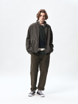 Men's Outfits 2022: Why not pair a dark brown bomber jacket with dark brown chinos? As well as totally comfortable, these pieces look cool combined together. And if you want to effortlessly dress down this outfit with a pair of shoes, why not introduce black and white canvas low top sneakers to the mix?